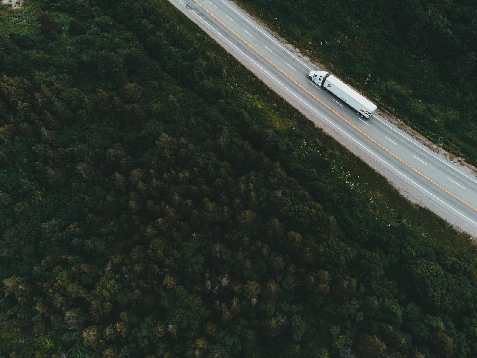 Container truck travelling along a road — supporting bonded freight transportation photograph