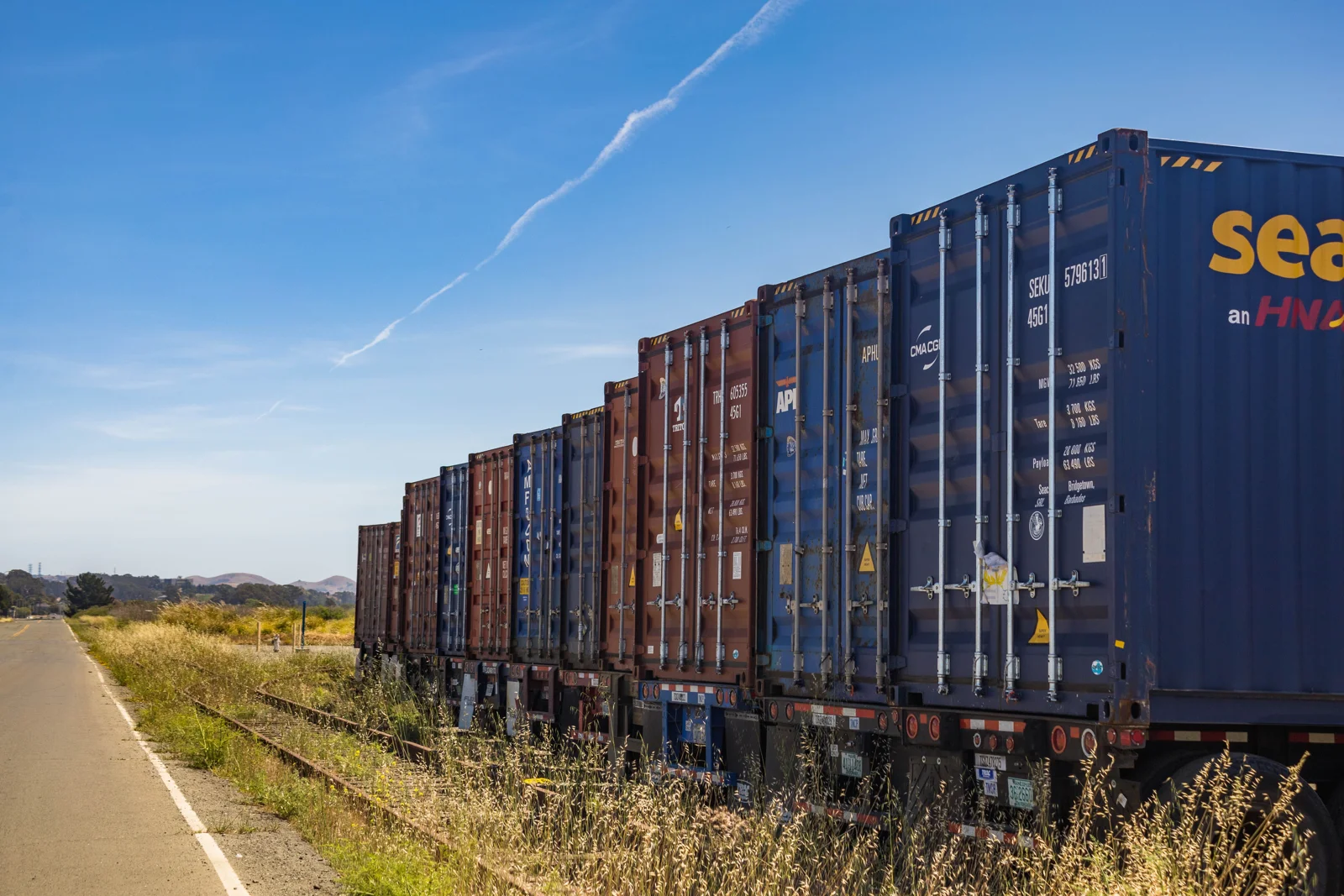 Freight train carrying shipping containers — illustrative rail logistics photograph
