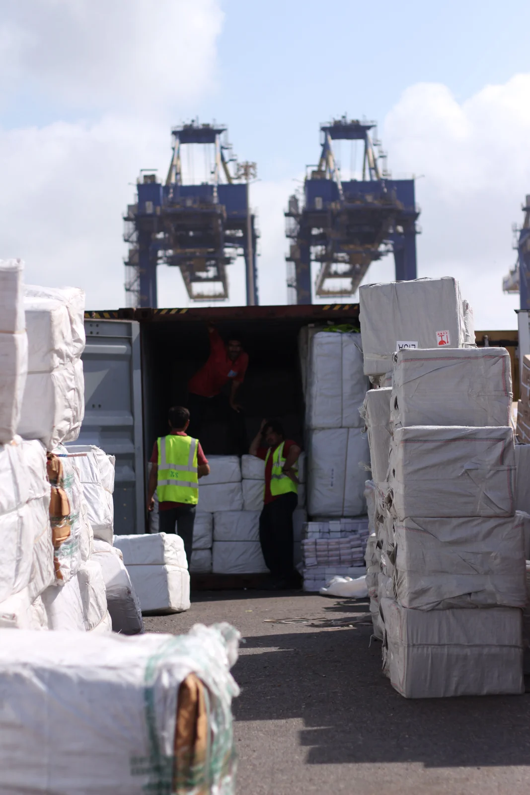 Dock workers loading cargo into a container at Karachi Port