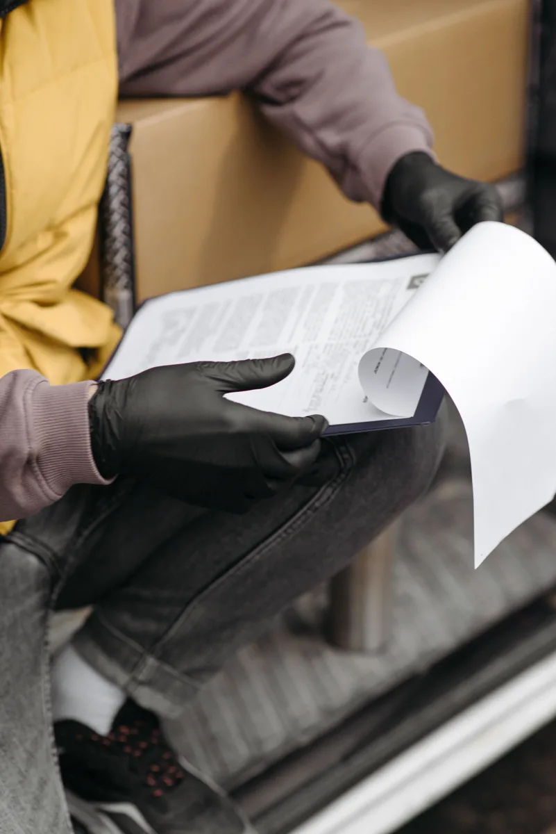 Delivery professional reviewing documents on a clipboard