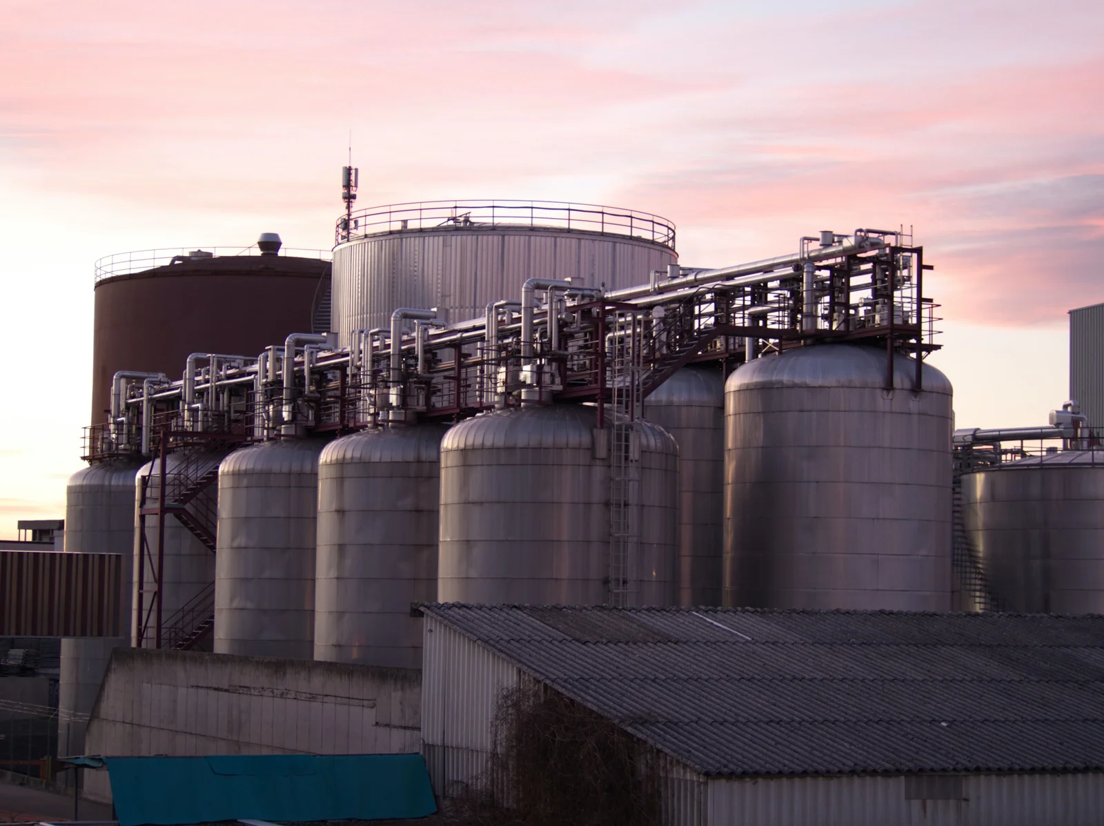 Industrial storage tanks and pipework at a processing facility