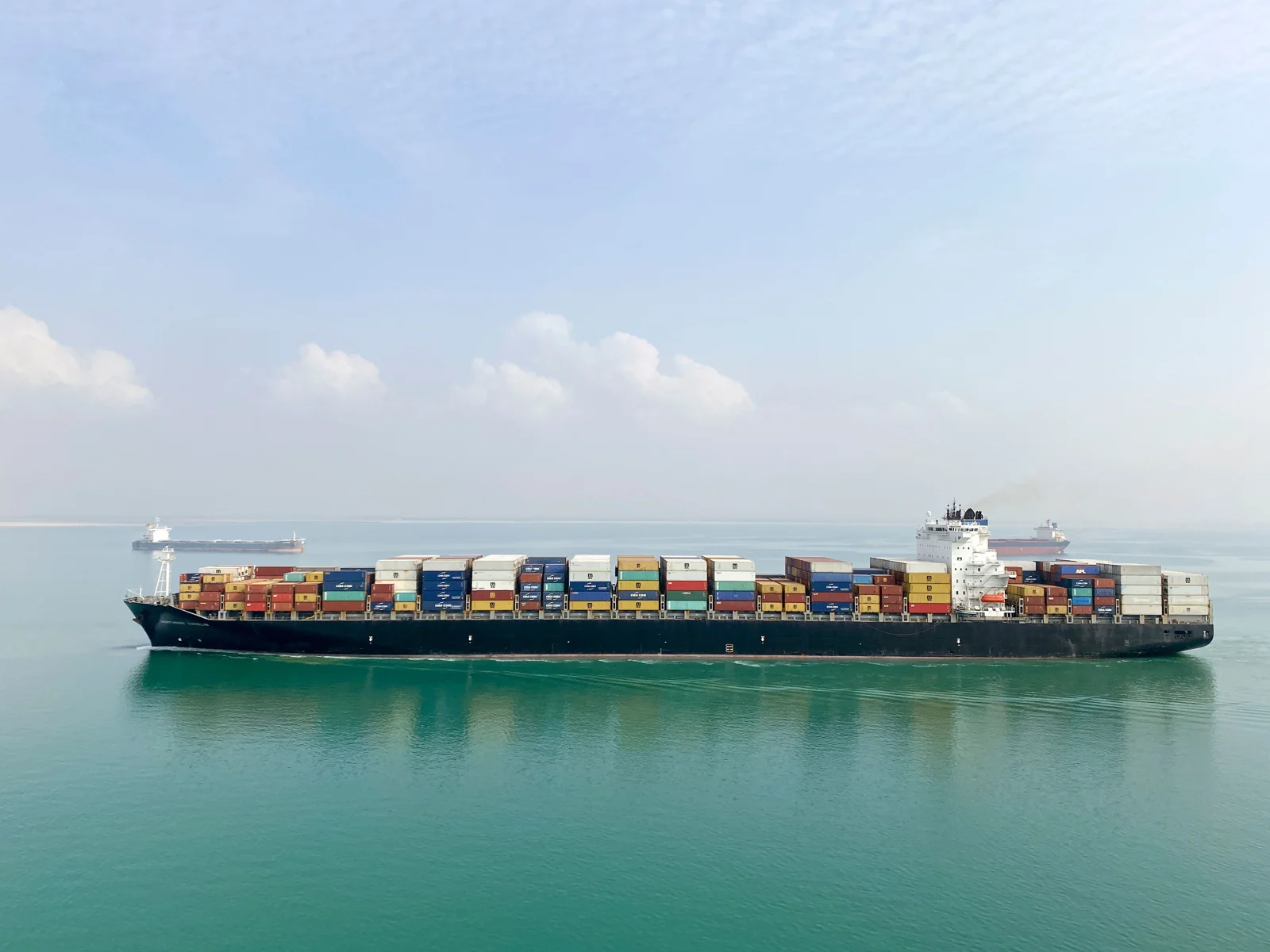 Container ship carrying cargo across the open sea